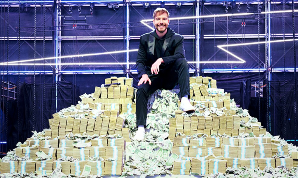 Mr Beast on pile of cash for Beast Games.